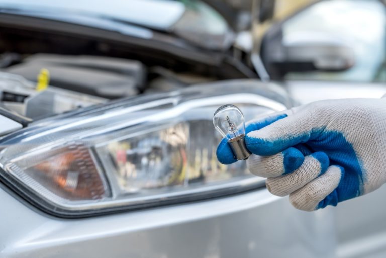 someone holding a car light bulb
