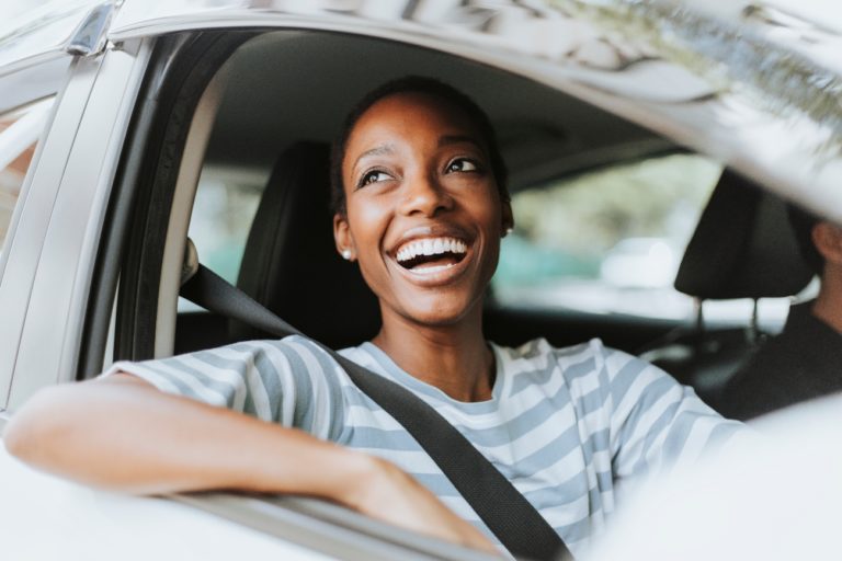 woman smiling while driving