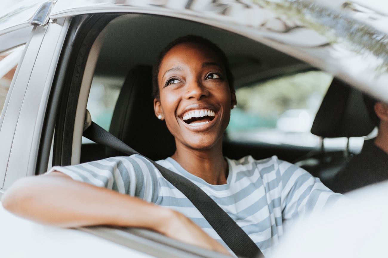 woman smiling while driving